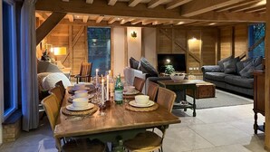 A cozy dining area with a wooden table set for a meal, surrounded by comfortable seating. - The Hen House (Ware)
