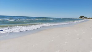 A beach with clear blue water, sandy shore, and footprints. - Royal Orleans 117 - Great value, first floor w/pool (Redington Beach)