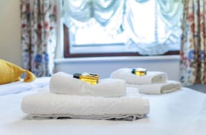 Guests can enjoy a comfortable night's sleep in this well-maintained room, complete with a made bed and amenities.