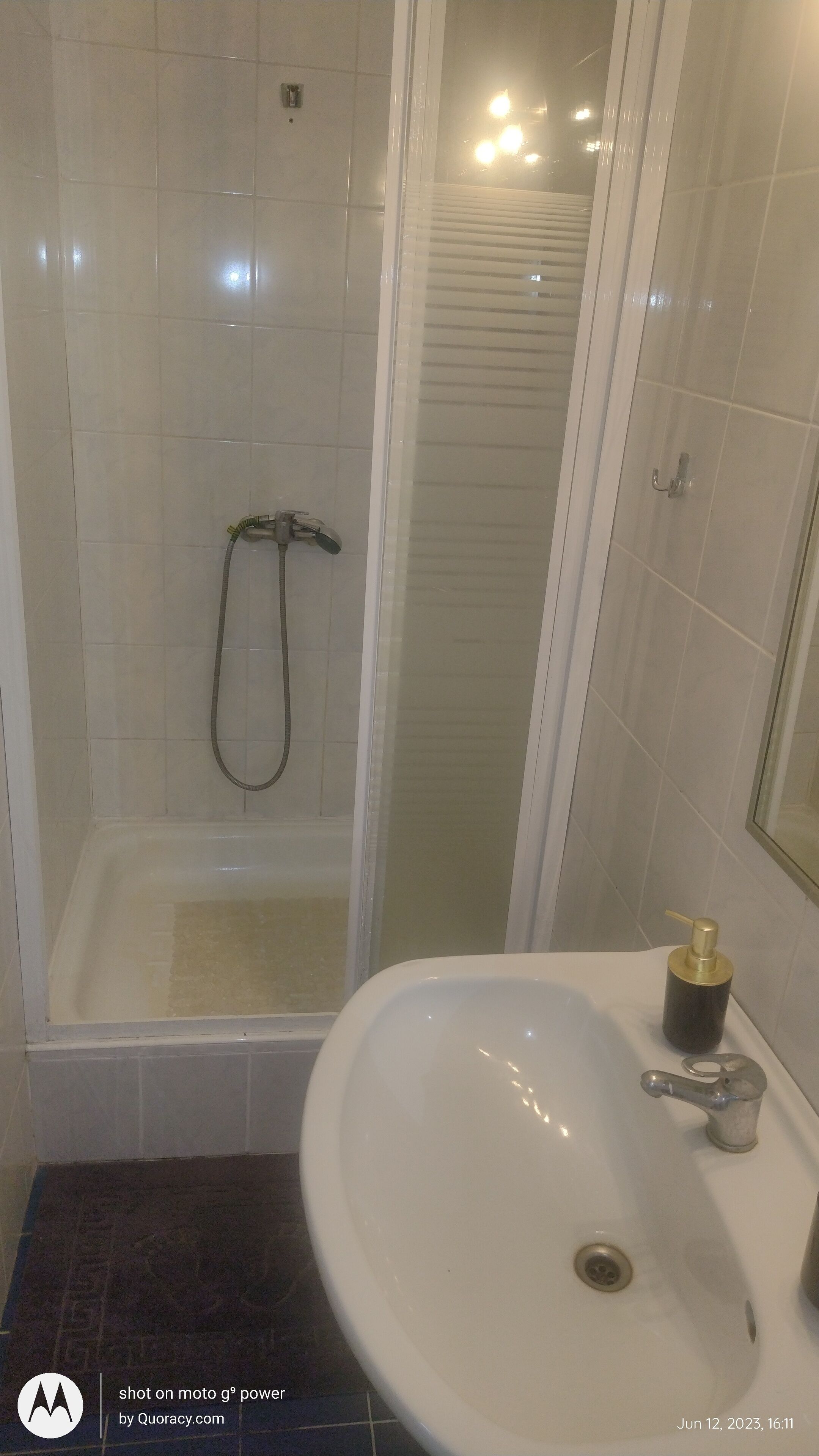 A bathroom with a bathtub, a shower, and a sink.