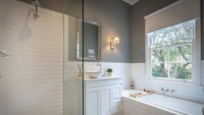Bathtub, hair dryer, towels, shampoo