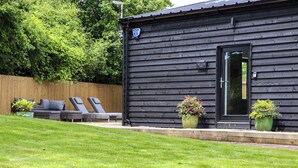 A black wooden building with a sign reading "The Goose Shed". - The Goose Shed (Canterbury)