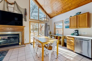 Enjoy meals in the kitchen with an oven and dining area near a large window offering a view of the outdoors.