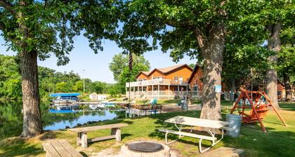 Lakefront condo with beach access, firepit, games, fireplace, & dock