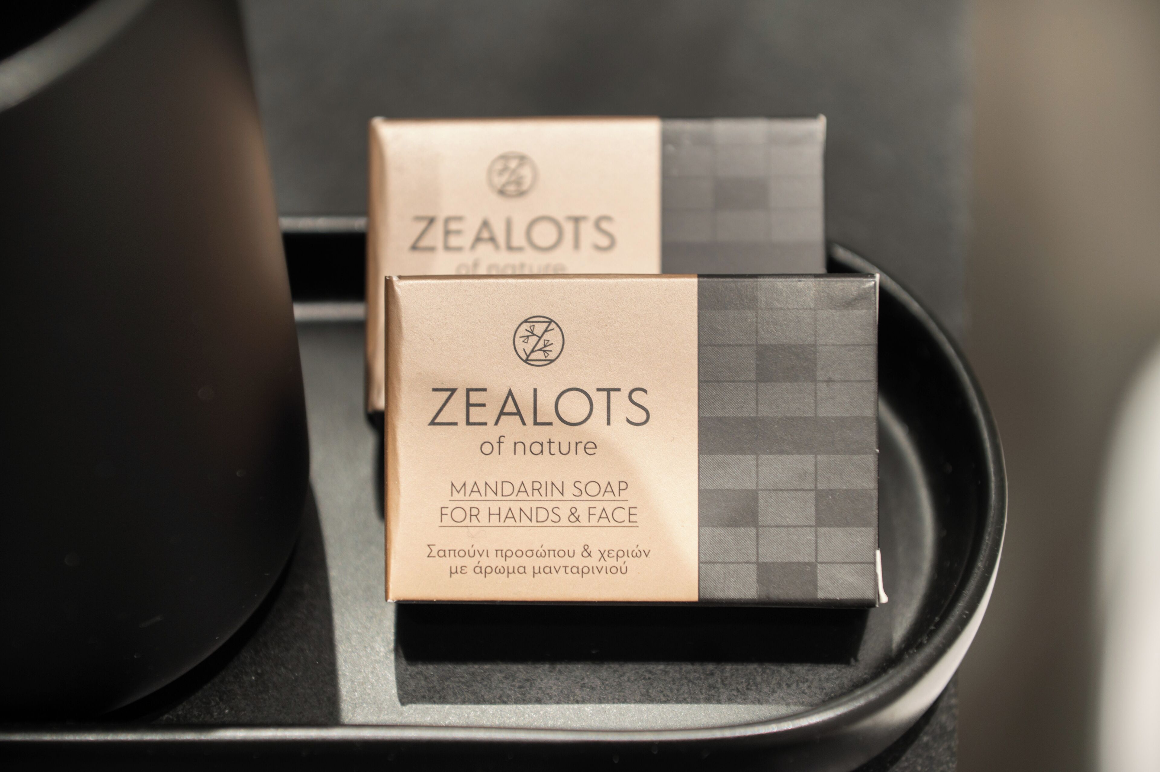 Two boxes of Zealots of Nature Mandarin Soap for Hands & Face on a black tray.