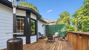 A wooden deck with outdoor seating, a grill, and a green wall. - Ranch Home w/ Backyard Retreat, Near Downtown Atl, Ask Flex Check In/Out! (Atlanta)