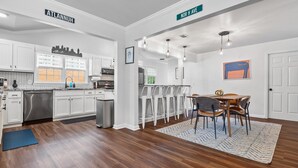 A modern kitchen with white cabinets, stainless steel appliances, and a herringbone tile backsplash. - Ranch Home w/ Backyard Retreat, Near Downtown Atl, Ask Flex Check In/Out! (Atlanta)