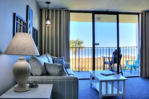Relax on the balcony with a view of the beach and ocean.