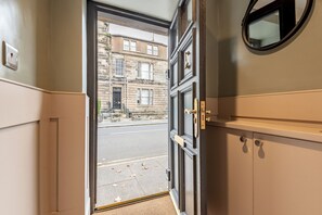 Une porte donnant sur une rue, avec des bâtiments en arrière-plan.