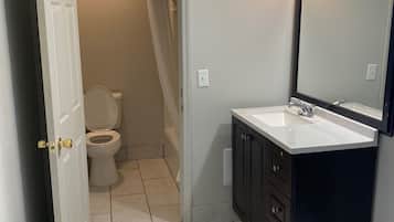 Bathtub, soap, shampoo, toilet paper