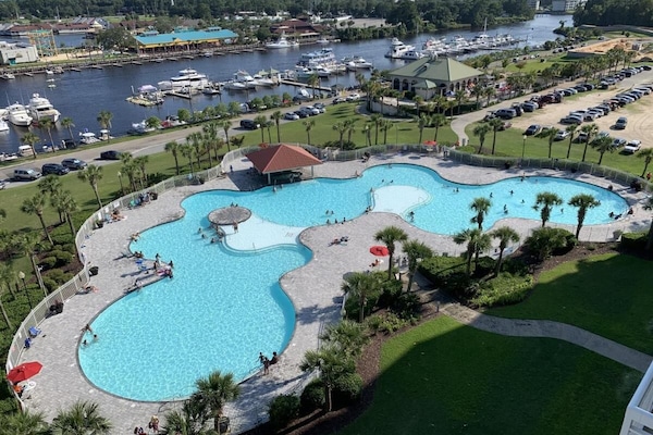 Aerial view of lagoon-style pool with tropical surroundings