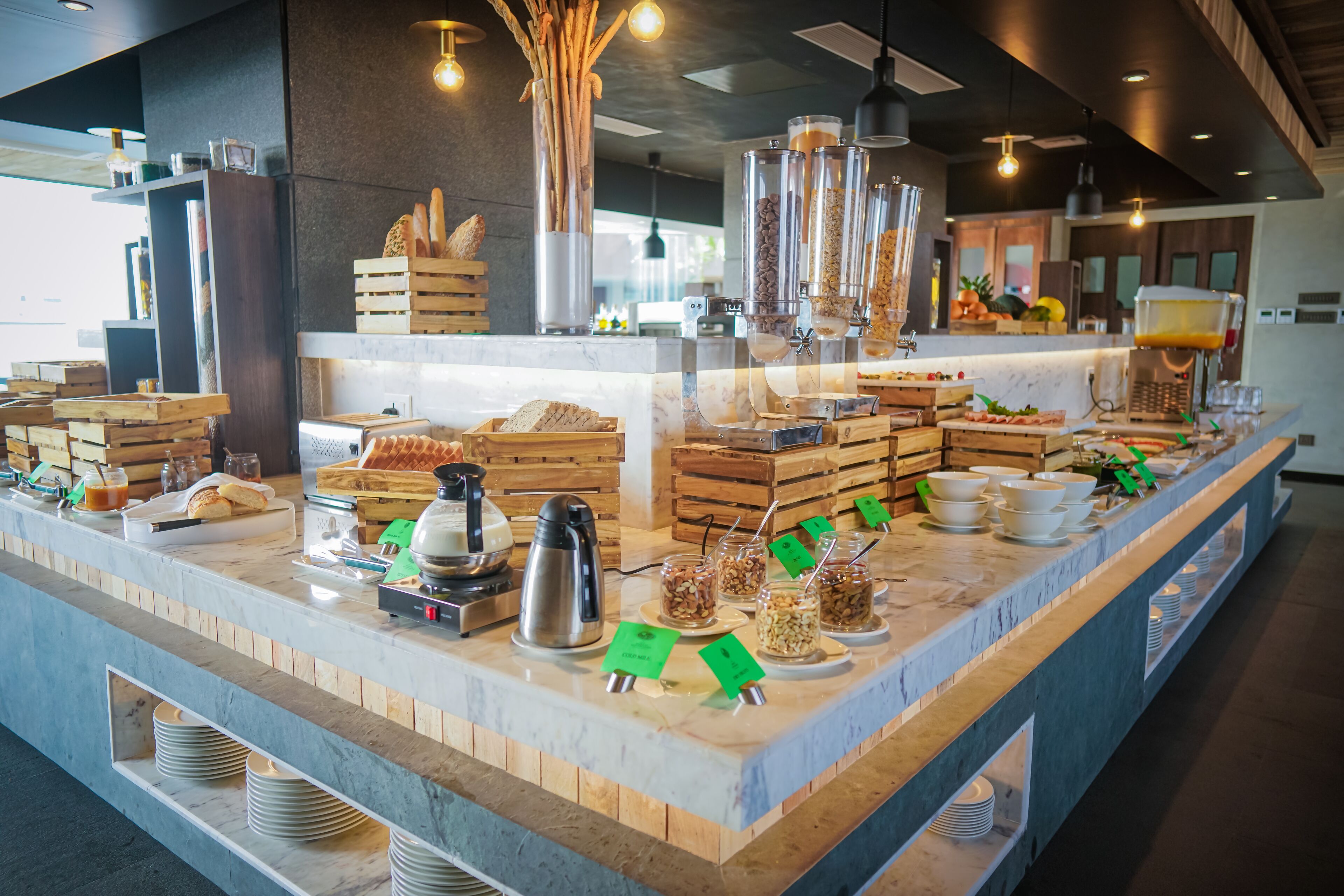 A buffet setup with various food items and utensils.