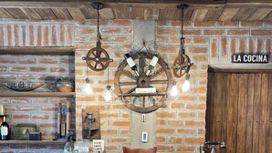 A rustic bar area with a brick wall, wooden ceiling, and a sign reading "LA COCINA". - Hacienda Santa Ana Lodging (Guamote)