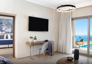A modern hotel room with a bed, a desk with a TV, a chair, a view of the ocean, and a balcony. - Ajul Luxury Hotel & Spa Resort Registry Collection (Kassandra)
