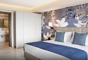 A modern bedroom with a large bed, a wardrobe, and a floral wall mural. - Ajul Luxury Hotel & Spa Resort Registry Collection (Kassandra)