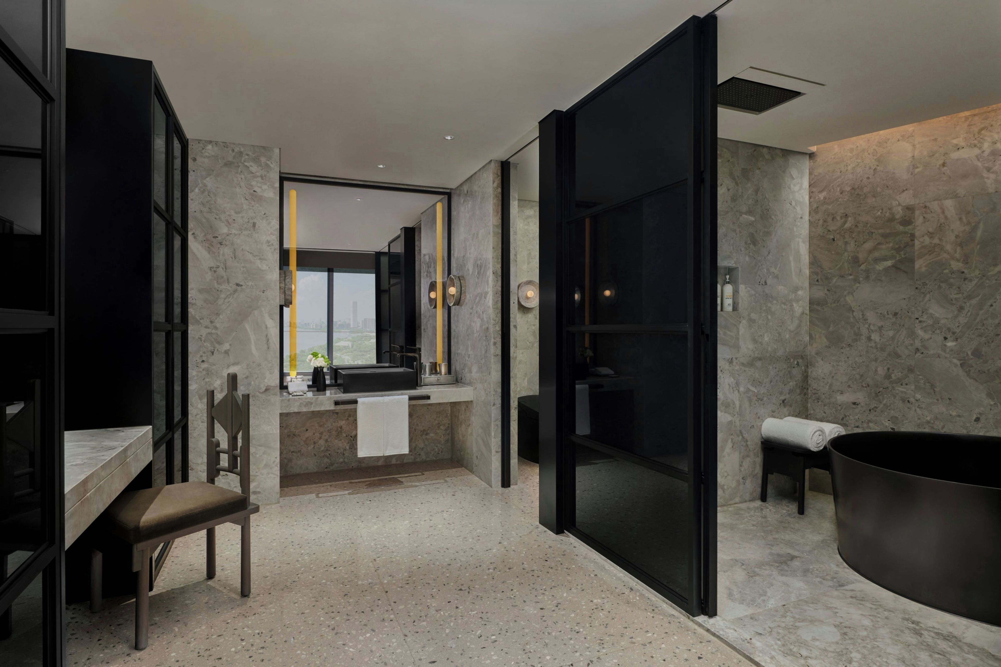 A modern bathroom with a large bathtub, a shower, and a sink area.