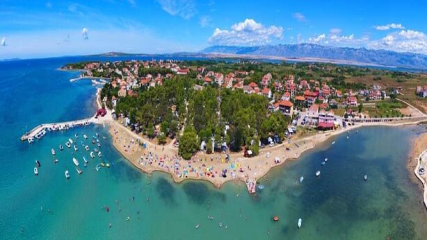 An aerial view of a coastal town with a beach, boats, and a mountainous backdrop. - Dalmatino Pleasure Mobile Home - Two Bedroom Mobile Home with Terrace (Privlaka)