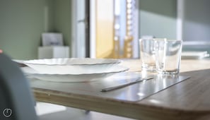 A dining table with a white plate, two glasses, and a spoon. - Italianway - Flavio Gioia 5 (Milan)