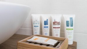 A bathroom with a white sink, four toiletry bags, and a wooden tray. - Italianway - Maggi 6 B (Milan)