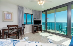 Enjoy ocean views from the balcony and relax in the spacious room with a flat-screen TV, dining area, and comfortable bed.