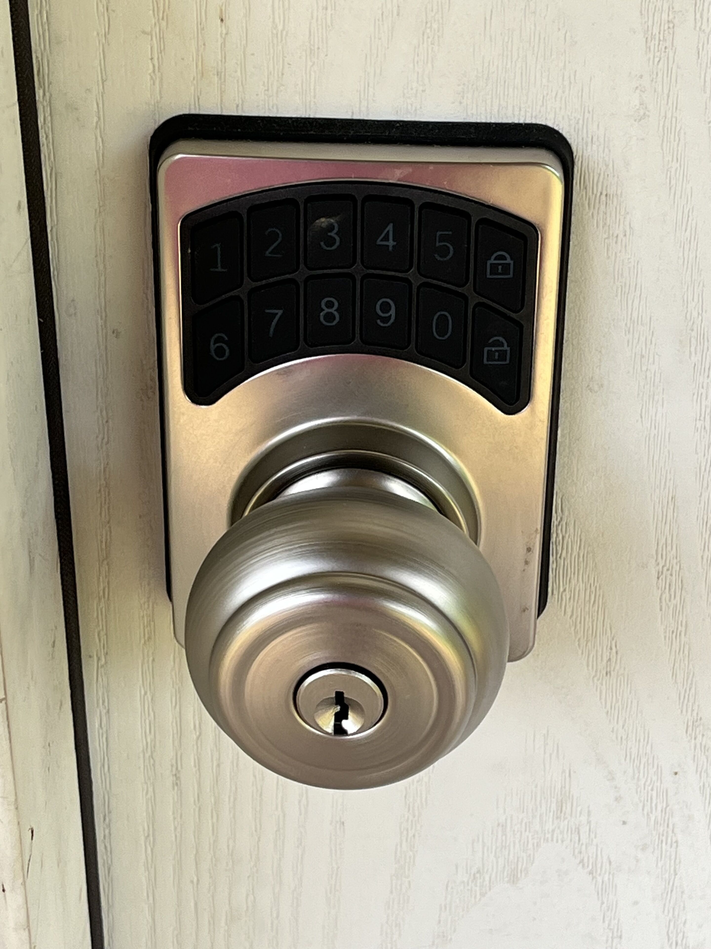 A modern numeric keypad lock on a door.