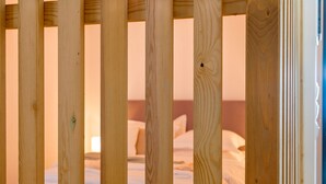 A wooden bed frame with a mattress and pillows. - Premium Deluxe Apartment -c2-common Terrace (Piraeus)