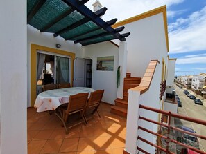 Enjoy al fresco dining on the sheltered balcony with a table for four and a beautiful pergola overhead.