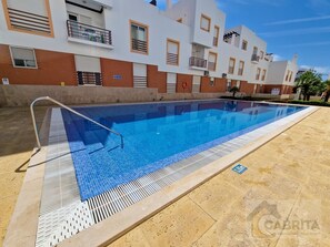 Enjoy a refreshing swim in the pool surrounded by a spacious deck area.