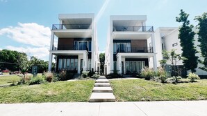 A modern two-story residential building with a central staircase leading to the entrance. - New! Downtown, Rooftop, Walkable to The Gulch, Music Row & 1M to Broadway! (Nashville)