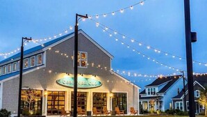 A building with a sign reading "beauty cast club" and outdoor seating. - A Block from the Dock in Beau Coast Classic (Beaufort)