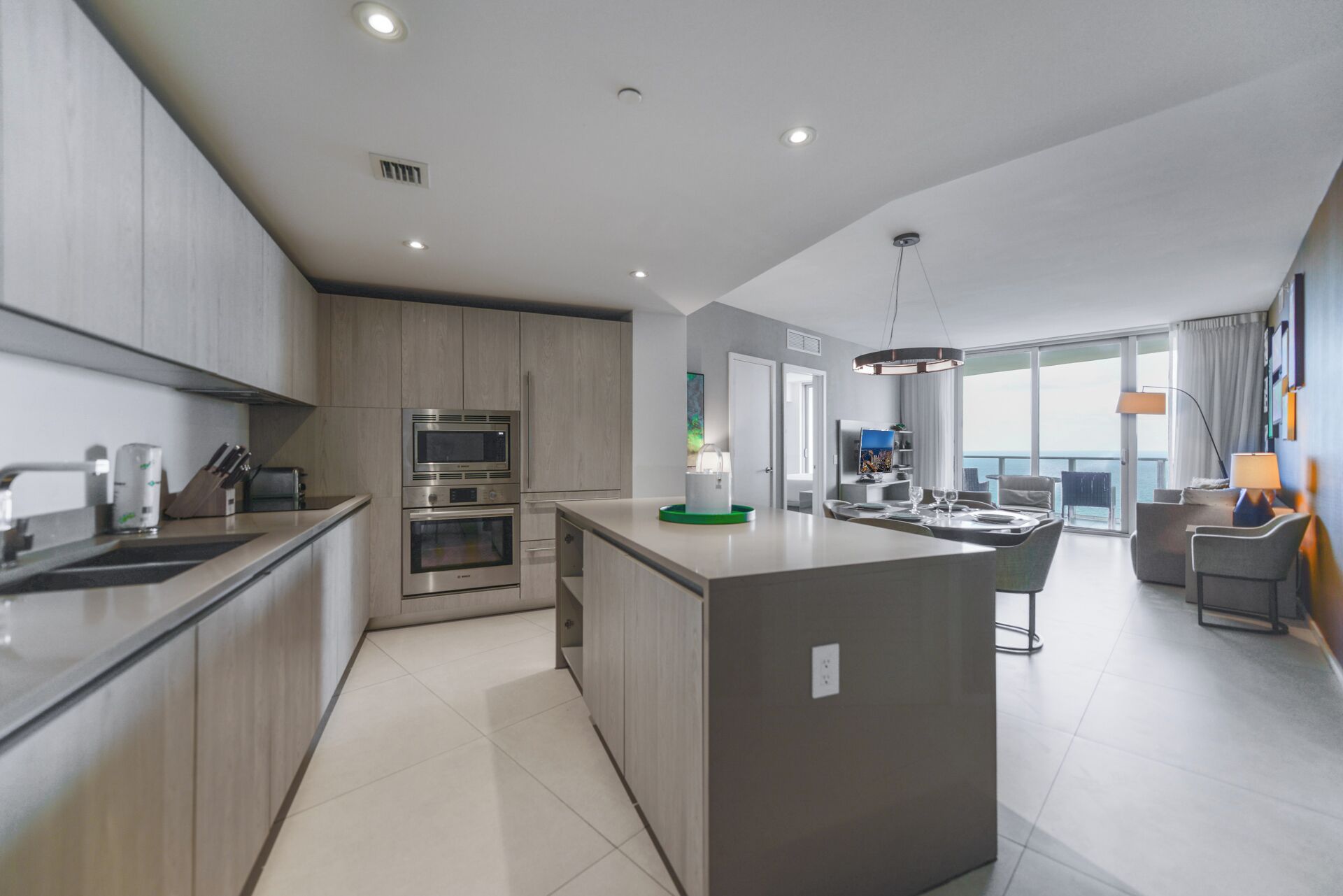 A modern kitchen with built-in appliances and a central island.