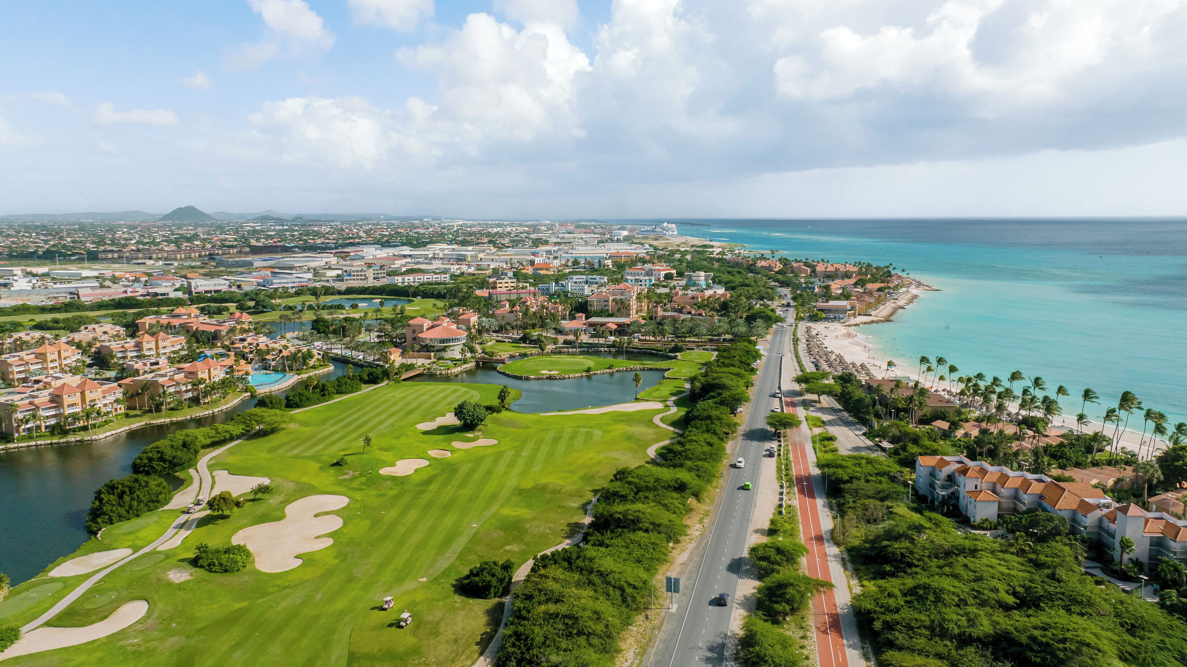 A coastal resort with a golf course, beachfront, and a marina.