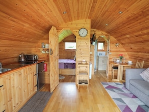 Cozy cabin with a compact layout, kitchenette, dining area, and comfortable seating area.