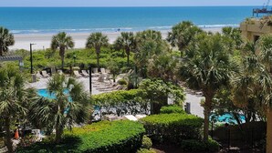 A resort with a pool, palm trees, and a beach view. - 108 Brighton 3 Bedroom Condo (Myrtle Beach)