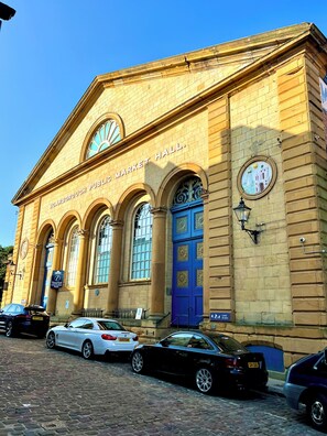 A historic building with a sign reading "Scarborough Public Market Hall."