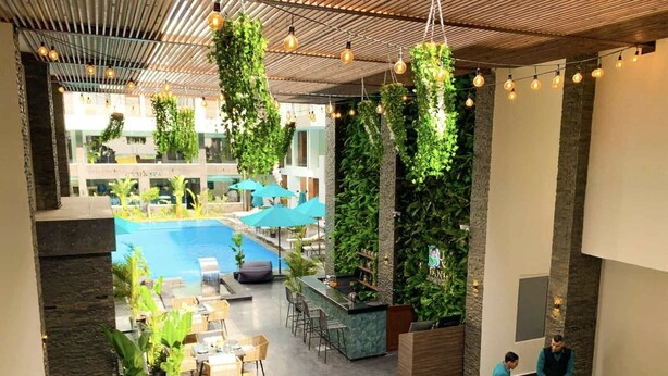 A modern indoor pool area with a lounge, seating, and a reception desk. - Bed/breakfast The 95m Penthouse Boutiqu spa Resort (Hurghada)