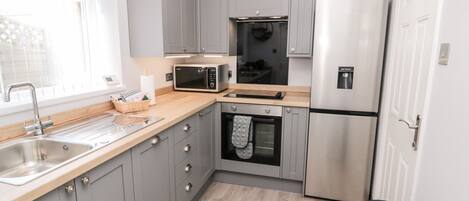 Fridge, electric kettle, toaster, cookware/dishes/utensils