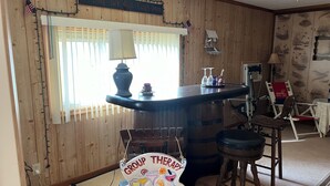 A wooden interior with a bar area, a sign reading "Group Therapy," and a window with blinds. - Lake Wateree cottage (Ridgeway)