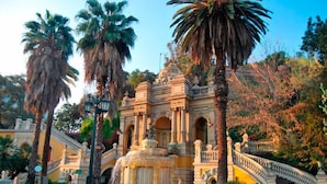A historic building with ornate architecture, a central fountain, and a bridge leading to it. - LOFT Hotel by Sommelier Hoteles (Santiago)
