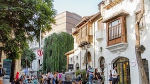 A street scene with pedestrians, bicycles, and historic buildings. - LOFT Hotel by Sommelier Hoteles (Santiago)