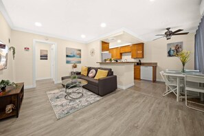 A modern living room with a sofa, coffee table, and a dining area with a table and chairs. - Cozy & Serene ~ 12 mins to Downtown LA (Alhambra)
