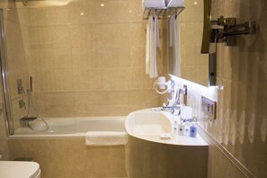 A modern bathroom with a bathtub, a round sink, and a mirror. - TIO SEA Resort AL Khor (Al Khor)