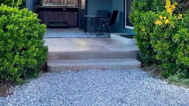 A modern house with a covered patio, a concrete driveway, and a well-maintained garden. - Quaint 1-bedroom Unit  w/ Hottub in Uptown Sedona (Sedona)