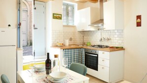 A kitchen with white cabinets, a gas stove, a sink, and a window with a view. - [Historic Center] A/C e WiFi in the Heart of Le Marche region (Lapedona)