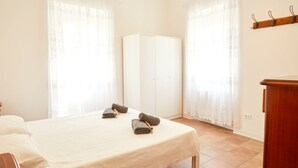 A bedroom with a bed, a wardrobe, and a desk. - [Historic Center] A/C e WiFi in the Heart of Le Marche region (Lapedona)