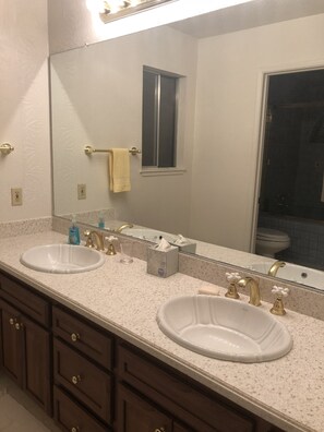 Bathroom features a double vanity with two sinks and a large mirror.
