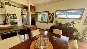 A dining area with a wooden table, chairs, and a decorative centerpiece. - Ballygelvar (Cambridge)