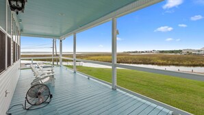 A covered porch with a view of a water body and grassy area. - Waterfront Oasis w/ Dock, Sleeps 12 (Bay St. Louis)