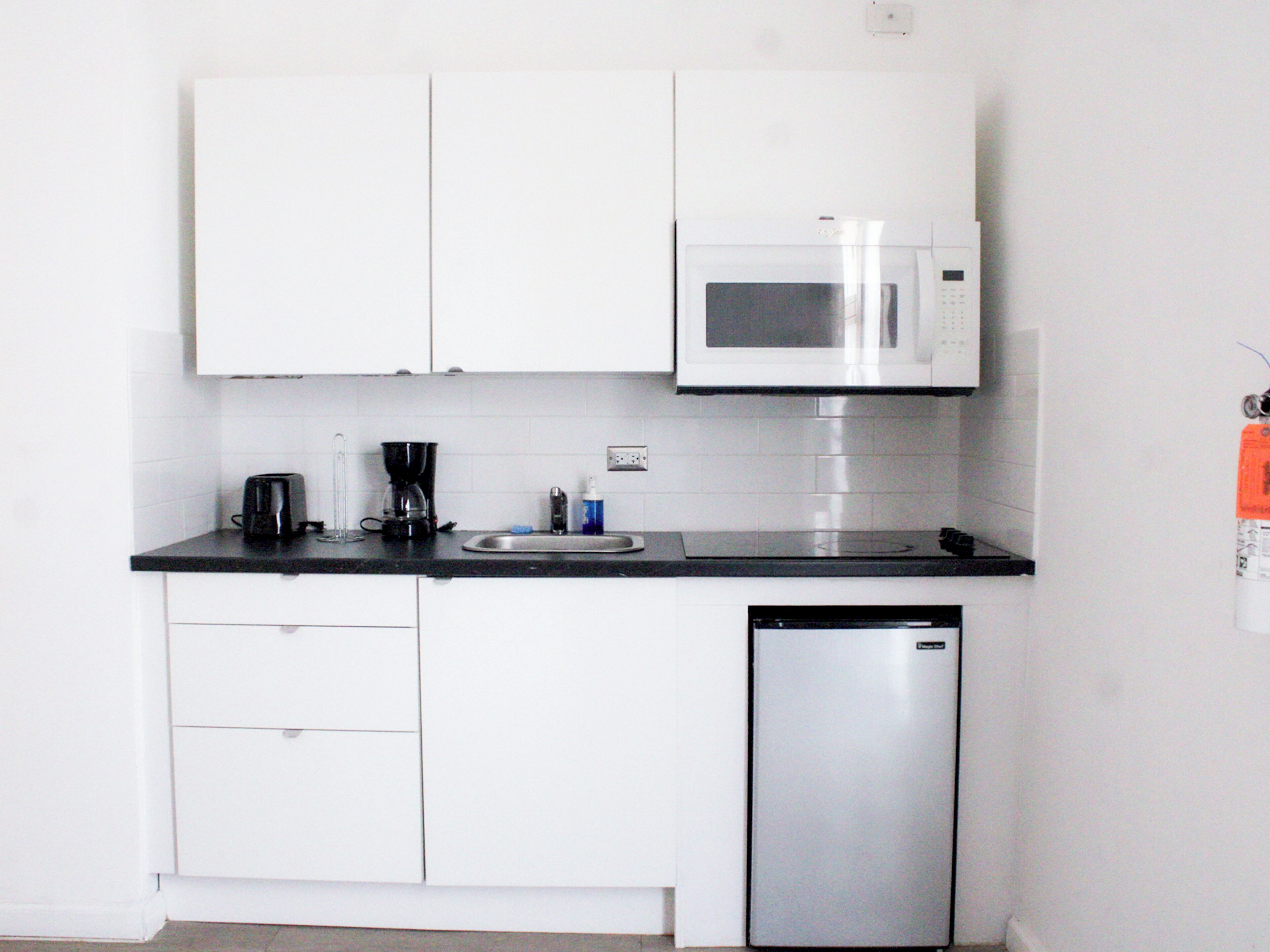 Fridge, microwave, coffee/tea maker, cookware/dishes/utensils