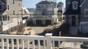 A residential area with multiple two-story houses, a covered walkway, and a fenced yard. - One off with Views! Long Beach Twsp. (Brant Beach)